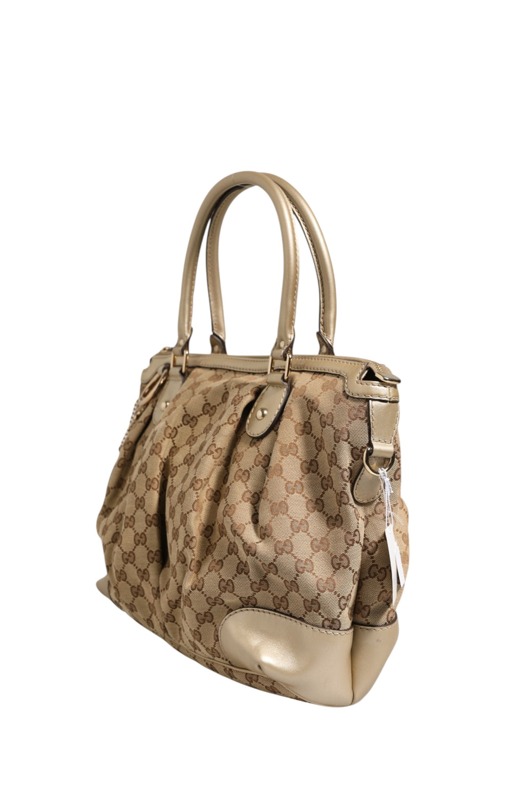 Sac à main Gucci Canvas Sukey Satchel en toile avec détails en cuir, porté sur l'épaule, style élégant et moderne.