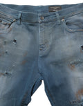 Jeans skinny en denim bleu délavé à taille moyenne de Dolce & Gabbana, coupe ajustée, détails déchirés sur le devant.