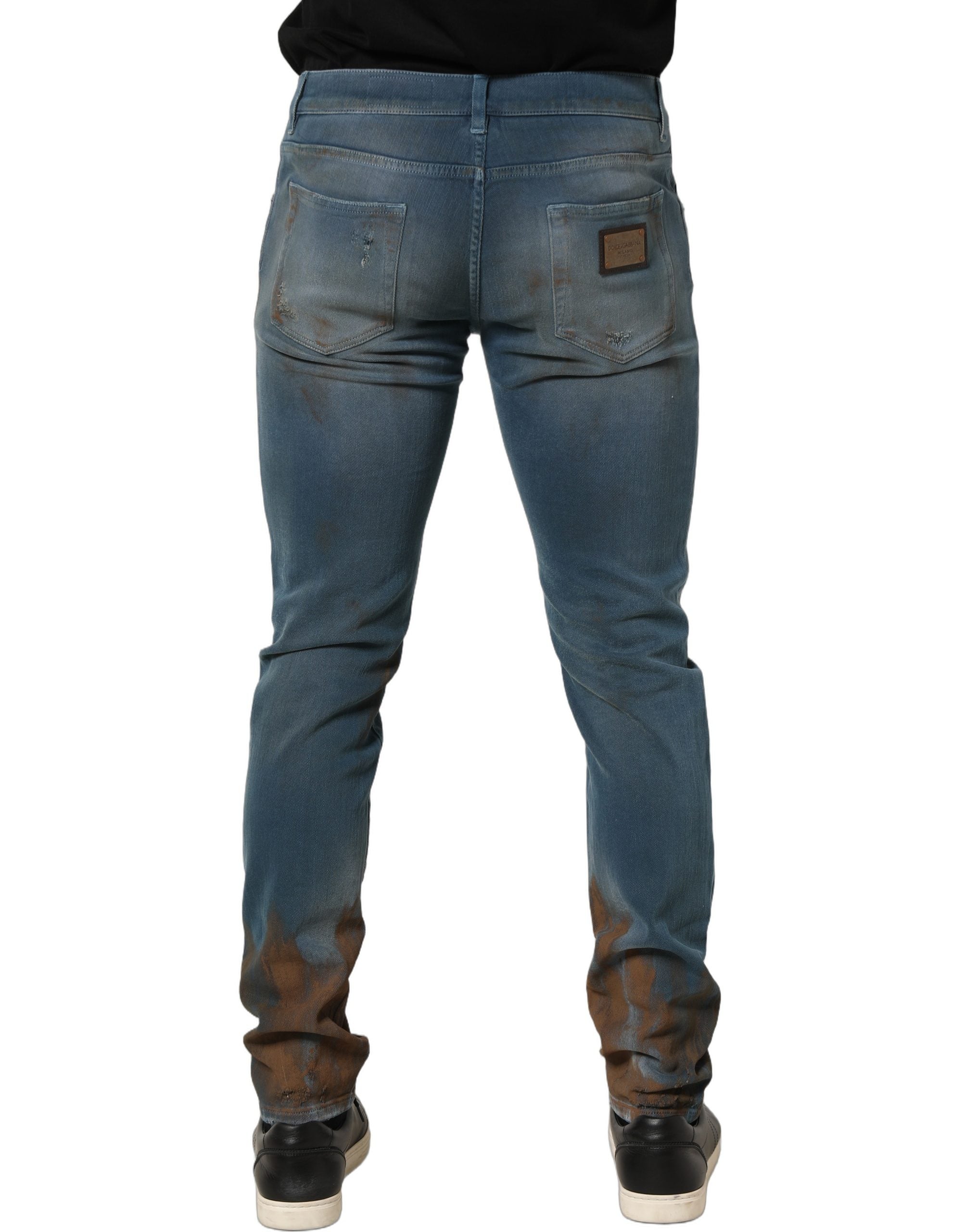 Jeans skinny en denim bleu déchiré à taille moyenne de Dolce & Gabbana, coupe ajustée et style décontracté.