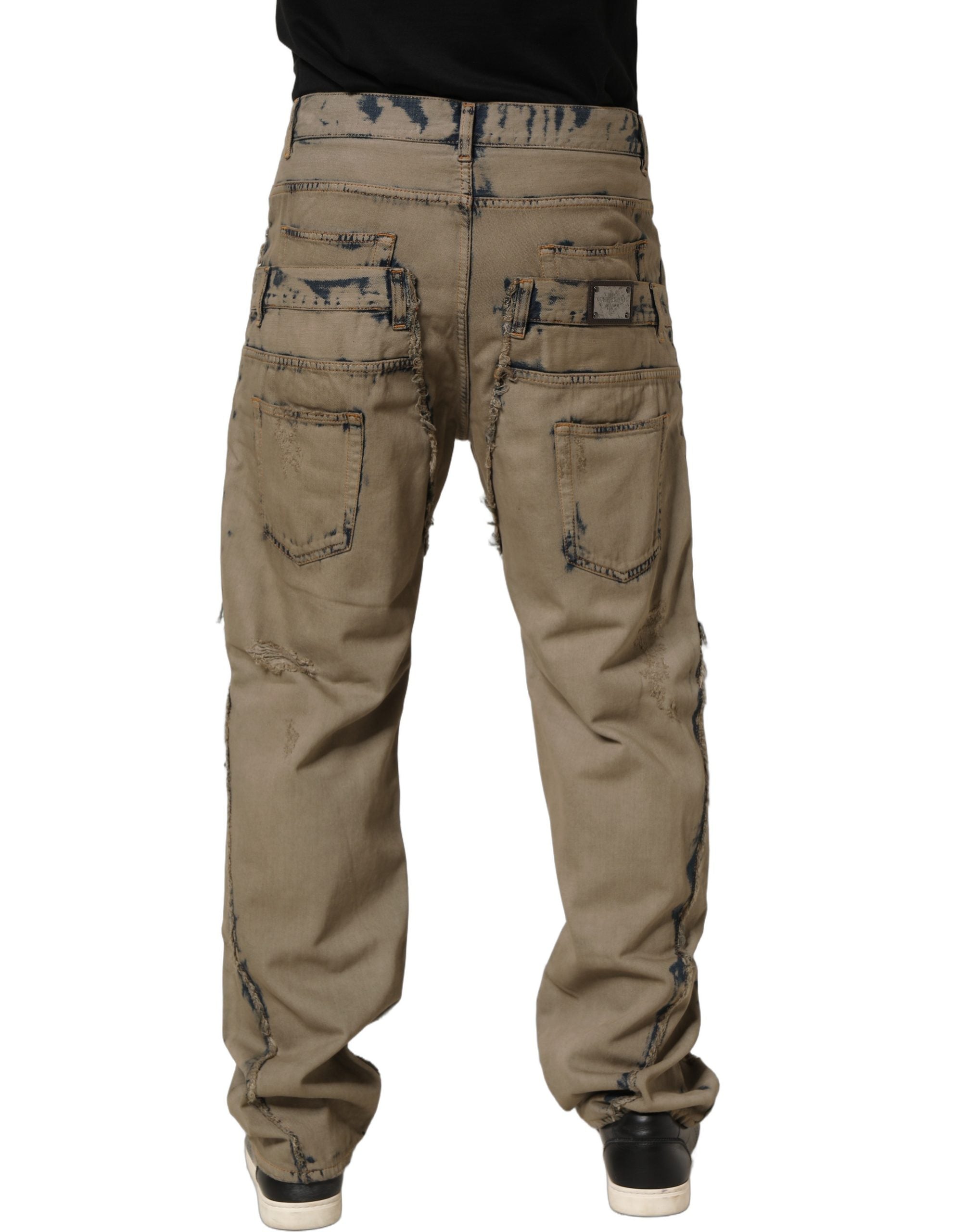 Jeans déchirés pour homme Dolce & Gabbana beige décoloré et déstructuré, en denim, visible en image.