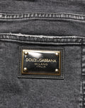 Jeans en denim gris foncé délavé Dolce & Gabbana, coupe taille moyenne, avec effets usés, vêtement tendance pour homme.