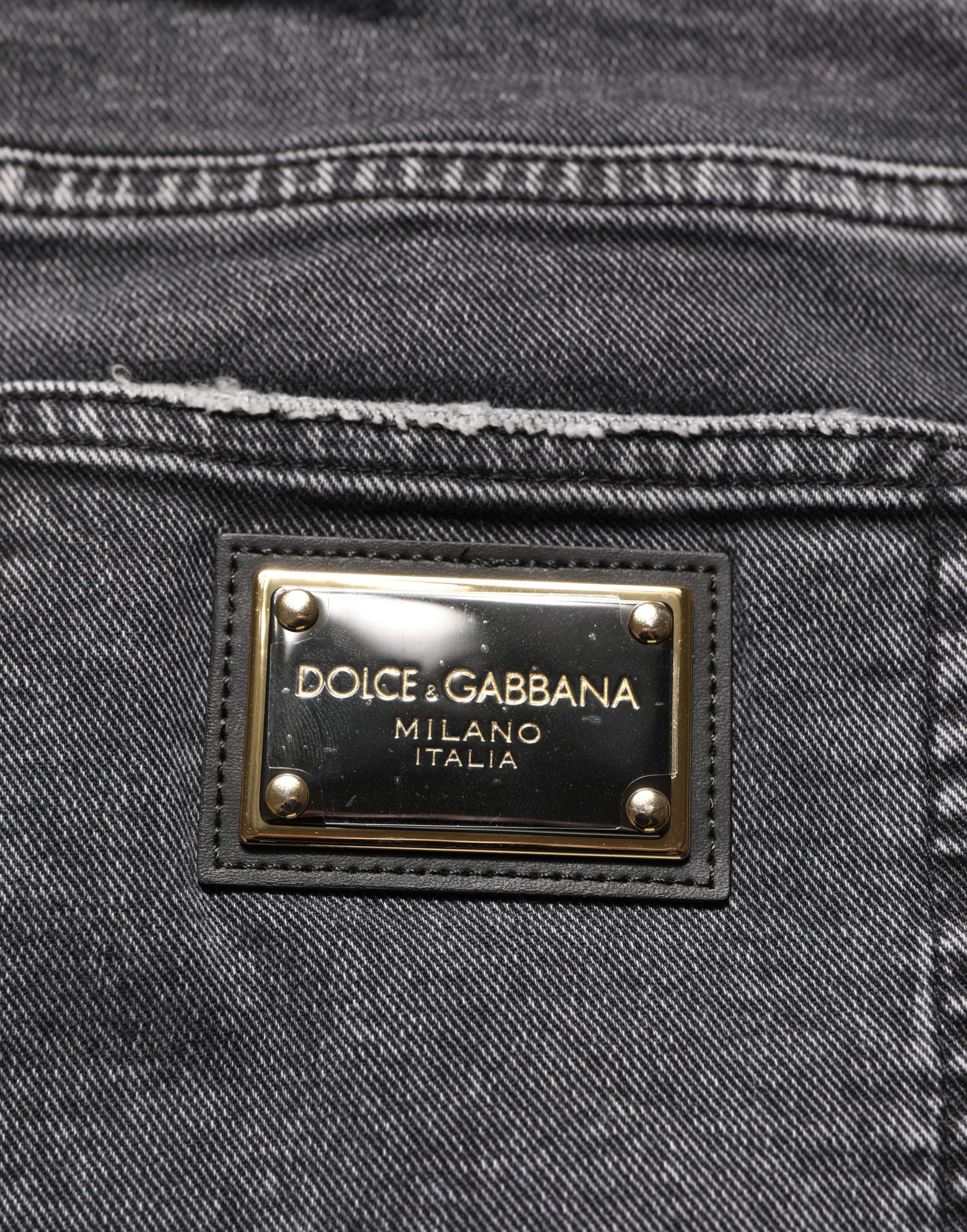 Jeans en denim gris foncé délavé Dolce & Gabbana, coupe taille moyenne, avec effets usés, vêtement tendance pour homme.