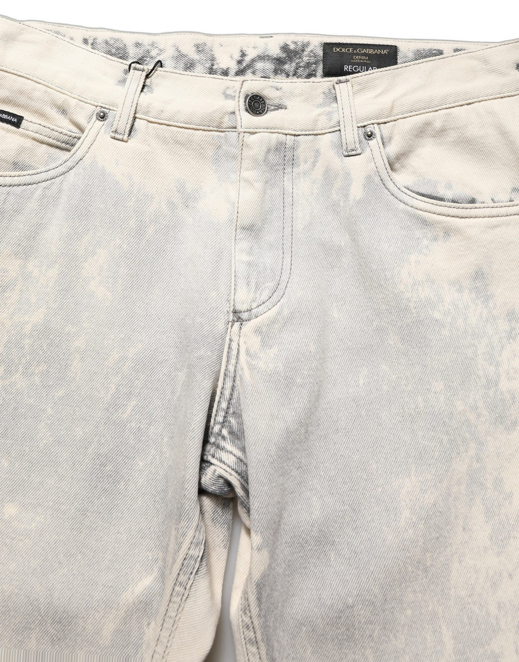 Jeans hommes Dolce & Gabbana en coton beige tie dye, coupe droite, style denim avec motif coloré.