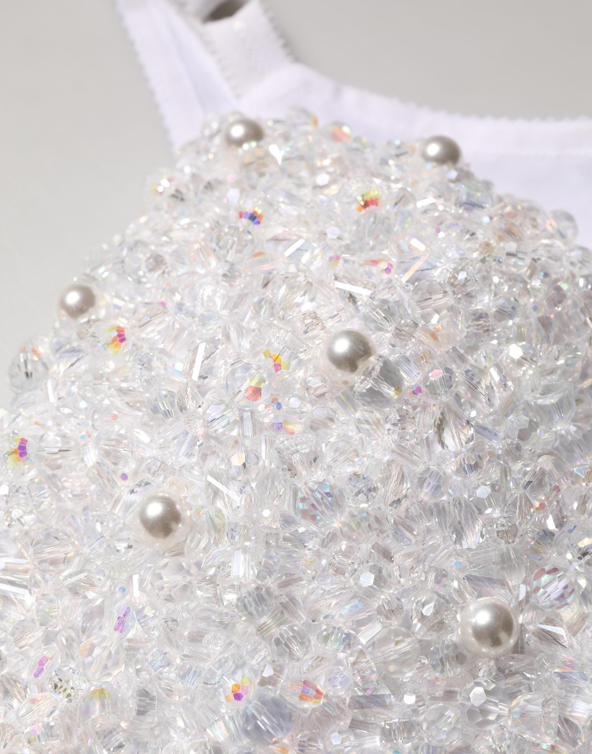 Corset bustier crop top blanc Dolce & Gabbana orné de perles, ajusté et élégant, parfait pour une tenue sophistiquée.