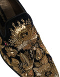 Chaussures loafers Dolce & Gabbana noires avec broderie dorée et détails élégants, pour un style sophistiqué.