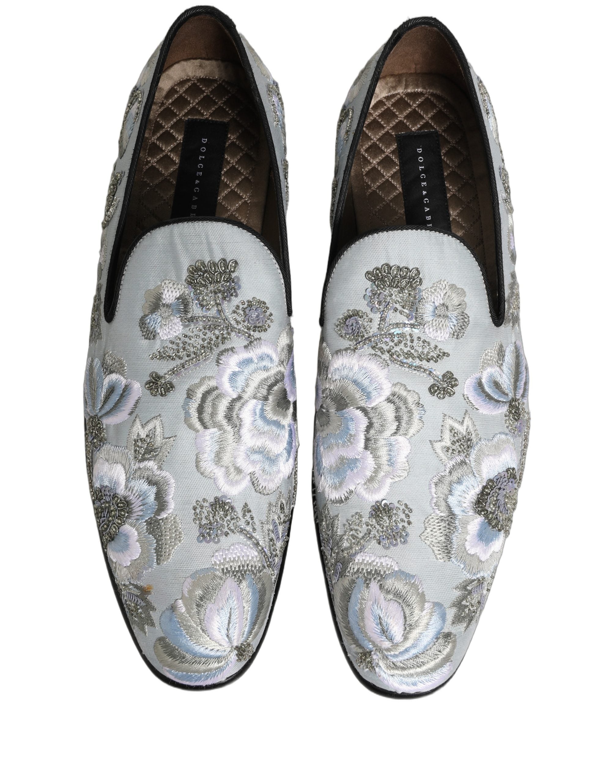 Chaussures mocassins pour hommes Dolce & Gabbana blanches avec motifs floraux et embellissements raffinés, style élégant et sophistiqué.