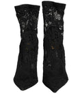 Chaussettes noires Dolce & Gabbana avec motifs, associées à des chaussures ou bottines en dentelle Taormina, élégantes et sophistiquées.