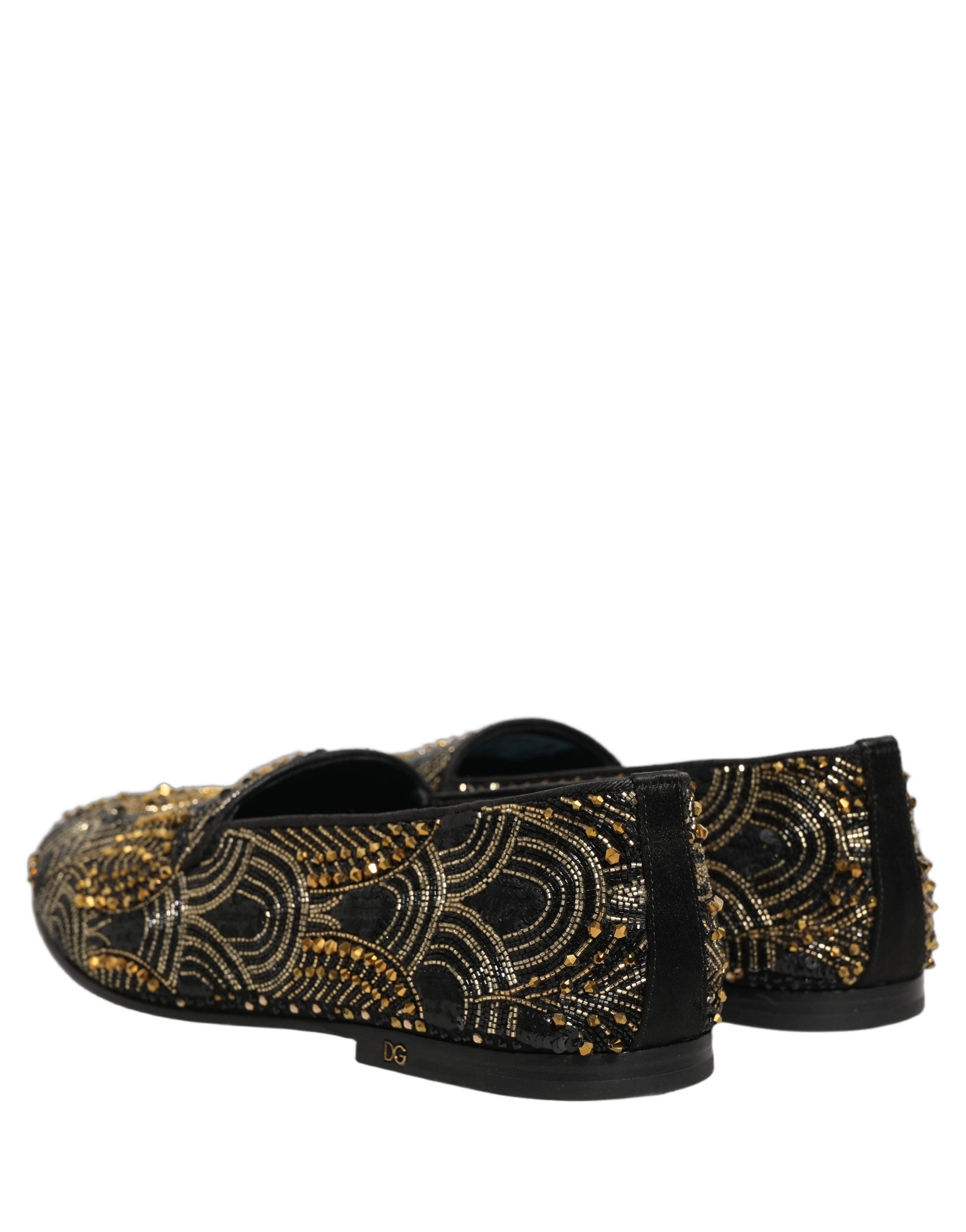 Chaussures loafers Dolce & Gabbana noires ornementées de détails dorés, élégantes et sophistiquées, vues en gros plan.