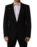 Veste blazer noire Dolce & Gabbana ornée de cristaux, élégante avec détails scintillants et coupe sophistiquée.