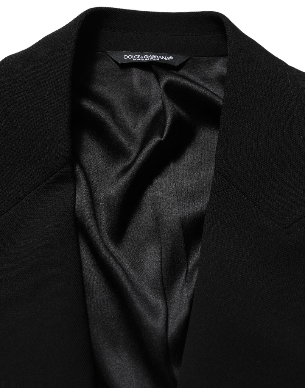 Blazer homme Dolce & Gabbana en laine noire, à boutonnière simple, style élégant et classique, porté sur un mannequin.