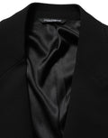 Blazer homme Dolce & Gabbana en laine noire, à boutonnière simple, style élégant et classique, porté sur un mannequin.
