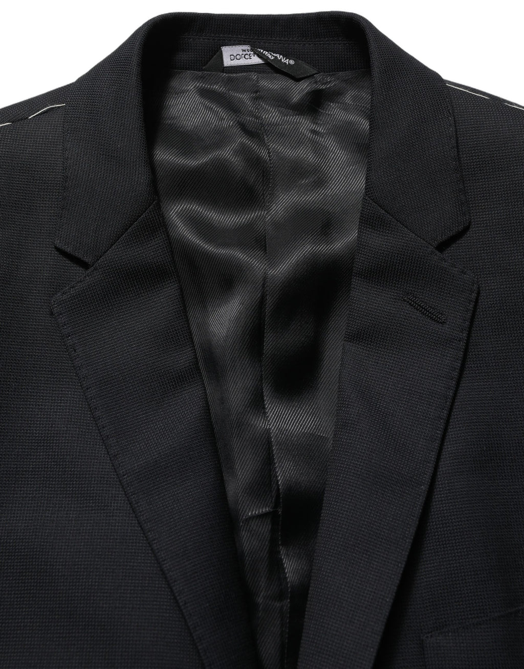 Blazer en laine noire Dolce & Gabbana, coupe simple à un bouton, élégant et ajusté, porté sur un mannequin.