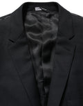 Blazer en laine noire Dolce & Gabbana, coupe simple à un bouton, élégant et ajusté, porté sur un mannequin.