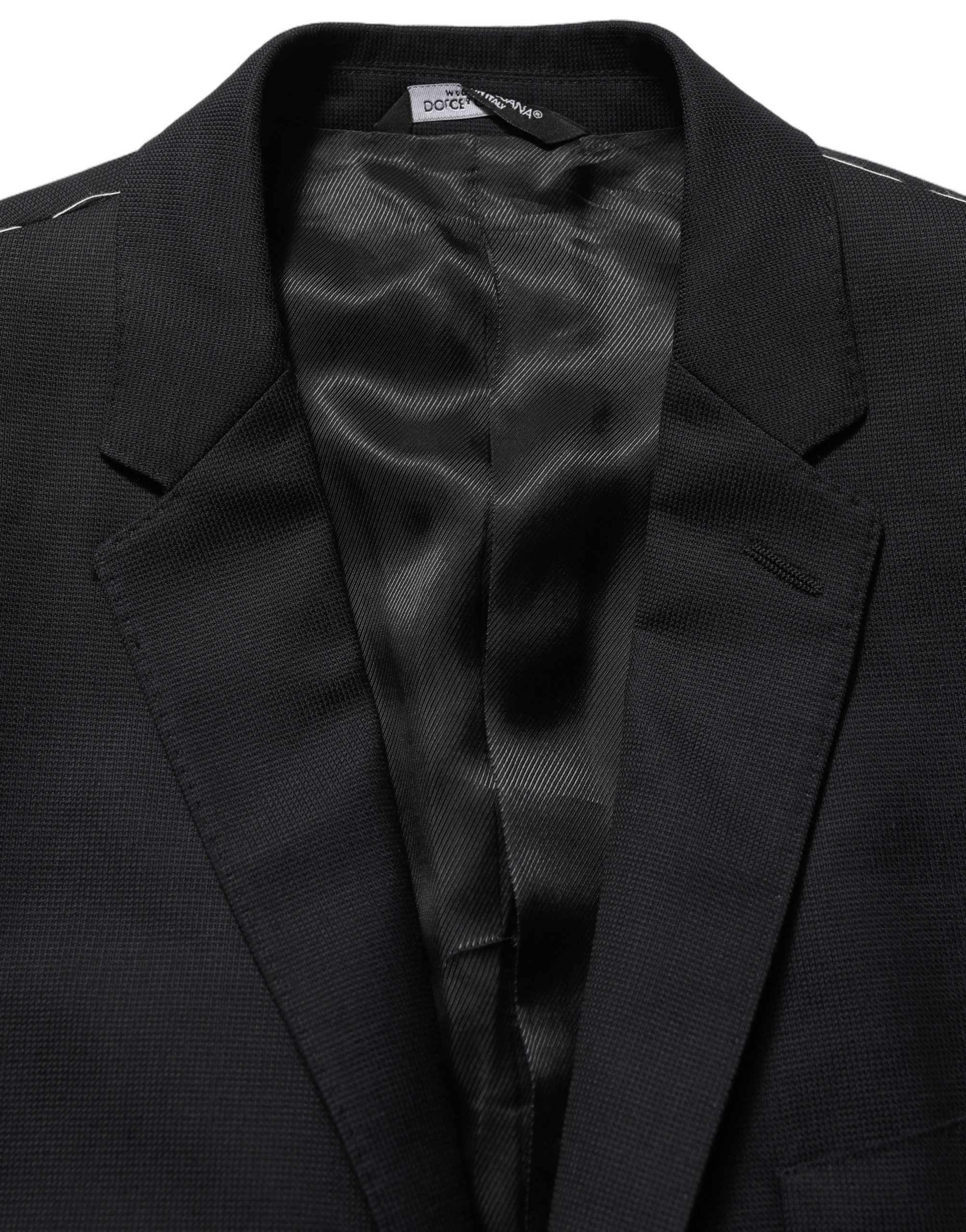 Blazer en laine noire Dolce & Gabbana, coupe simple à un bouton, élégant et ajusté, porté sur un mannequin.