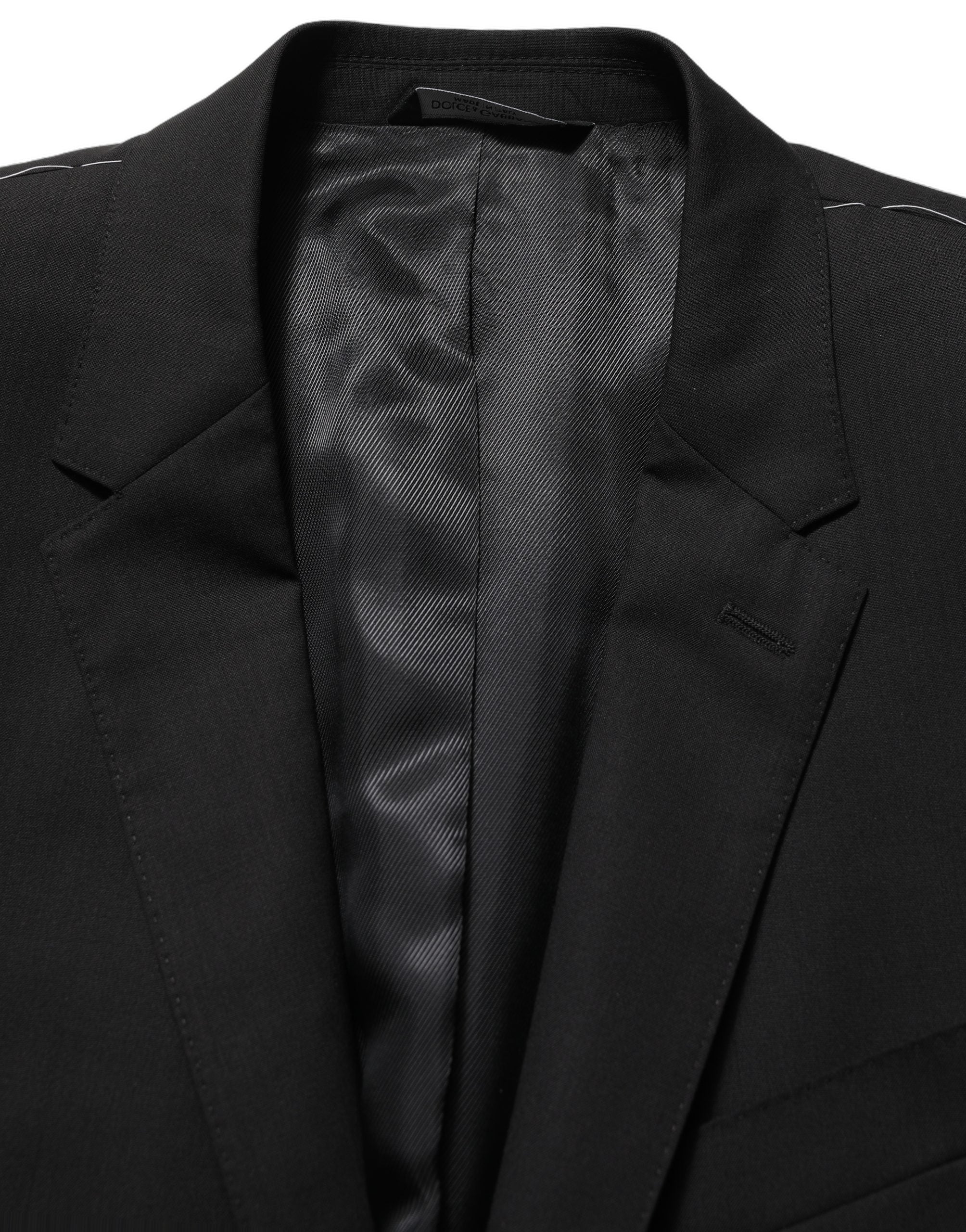 Blazer noir en laine Dolce & Gabbana à un bouton, coupe classique, porté sur un mannequin, détails de couture visibles.