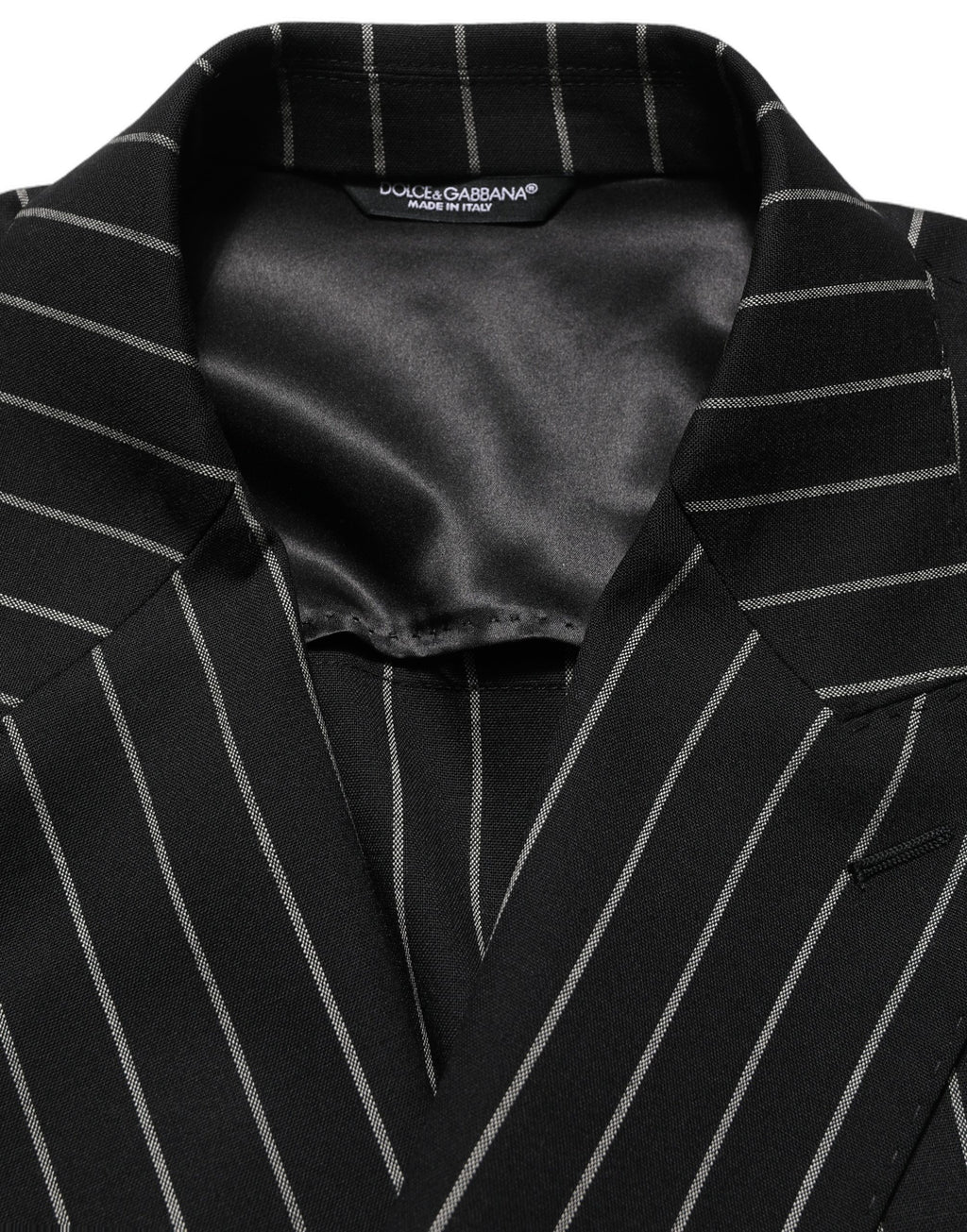 Veste en laine à rayures noires Dolce & Gabbana, à double boutonnage, élégante et sophistiquée.