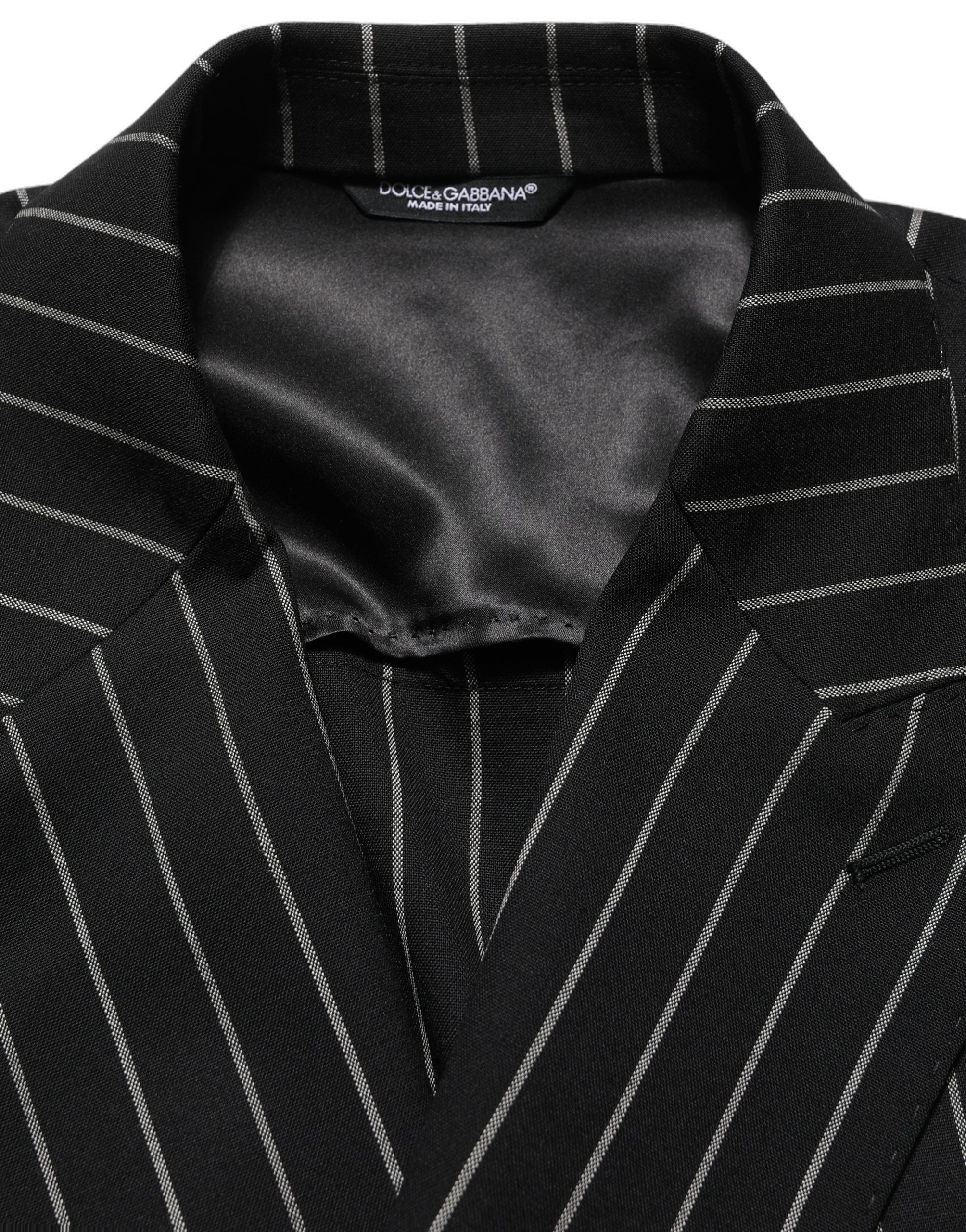 Veste en laine à rayures noires Dolce & Gabbana, à double boutonnage, élégante et sophistiquée.