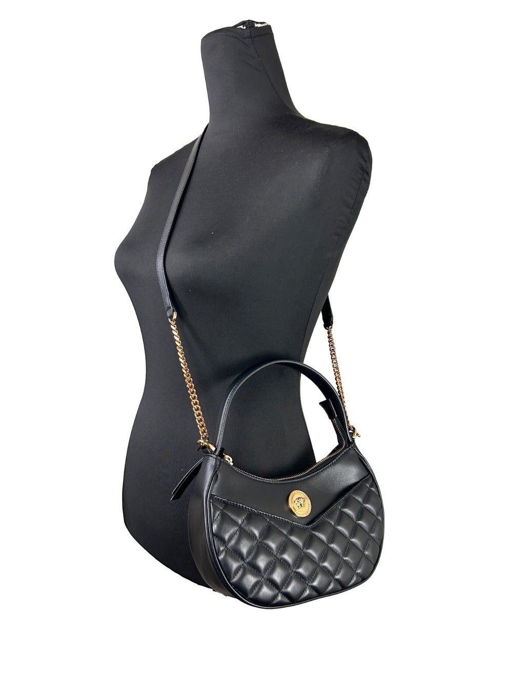 Sac à main crossbody en cuir noir matelassé Versace avec chaîne en demi-lune et détails élégants.