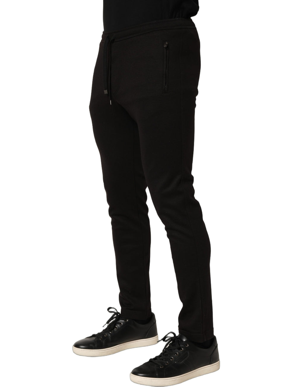 Pantalon jogger en laine noire de Dolce & Gabbana pour homme, sweatpants modernes avec ceinture élastique et poches latérales.
