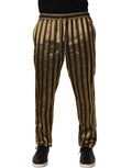 Pantalons pour homme Dolce & Gabbana en satin noir et or à rayures, coupe tapered, visible en détail sur l'image.