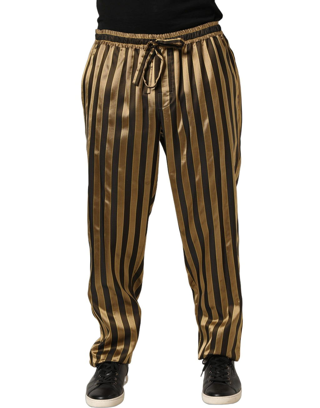 Pantalons en satin Dolce & Gabbana à rayures noires et dorées, coupe tapered, style élégant et sophistiqué.