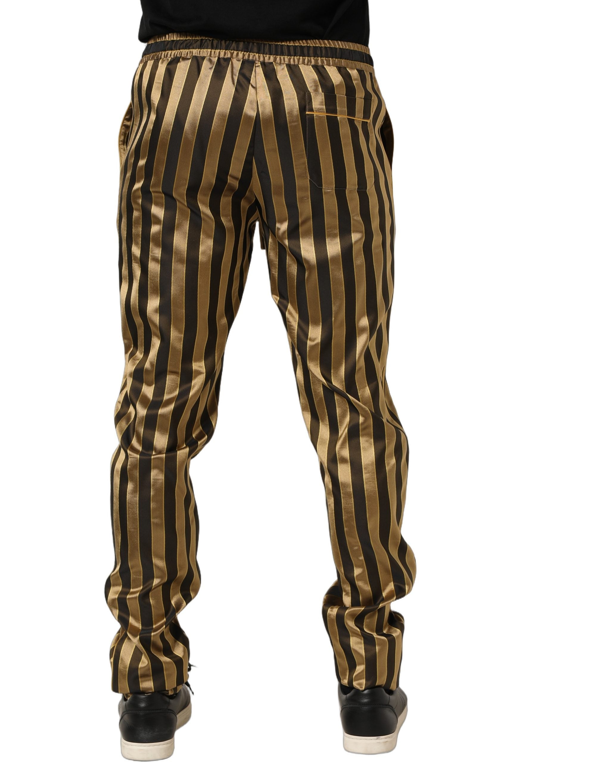 Pantalon pour homme en satin noir et or à rayures, coupe tapered, de la marque Dolce & Gabbana.