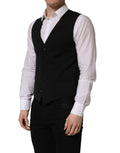Gilet en laine noir Dolce & Gabbana à boutonnière simple, ajusté, avec col en V et détails élégants pour homme.