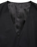 Gilet en laine noire Dolce & Gabbana à boutonnière simple, coupe ajustée et élégante, porté sur un mannequin.