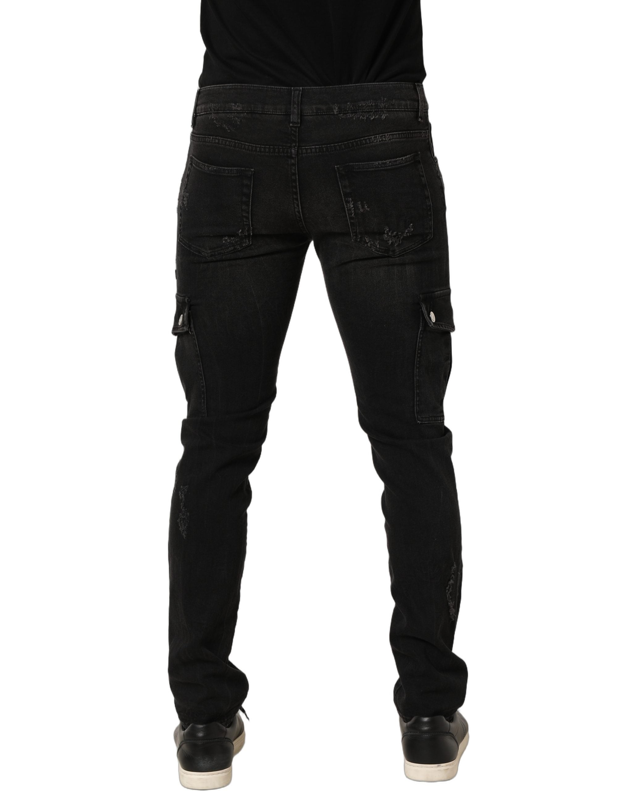 Jeans homme en coton noir déchiré de style cargo de Dolce & Gabbana, denim avec détails usés et poches larges.