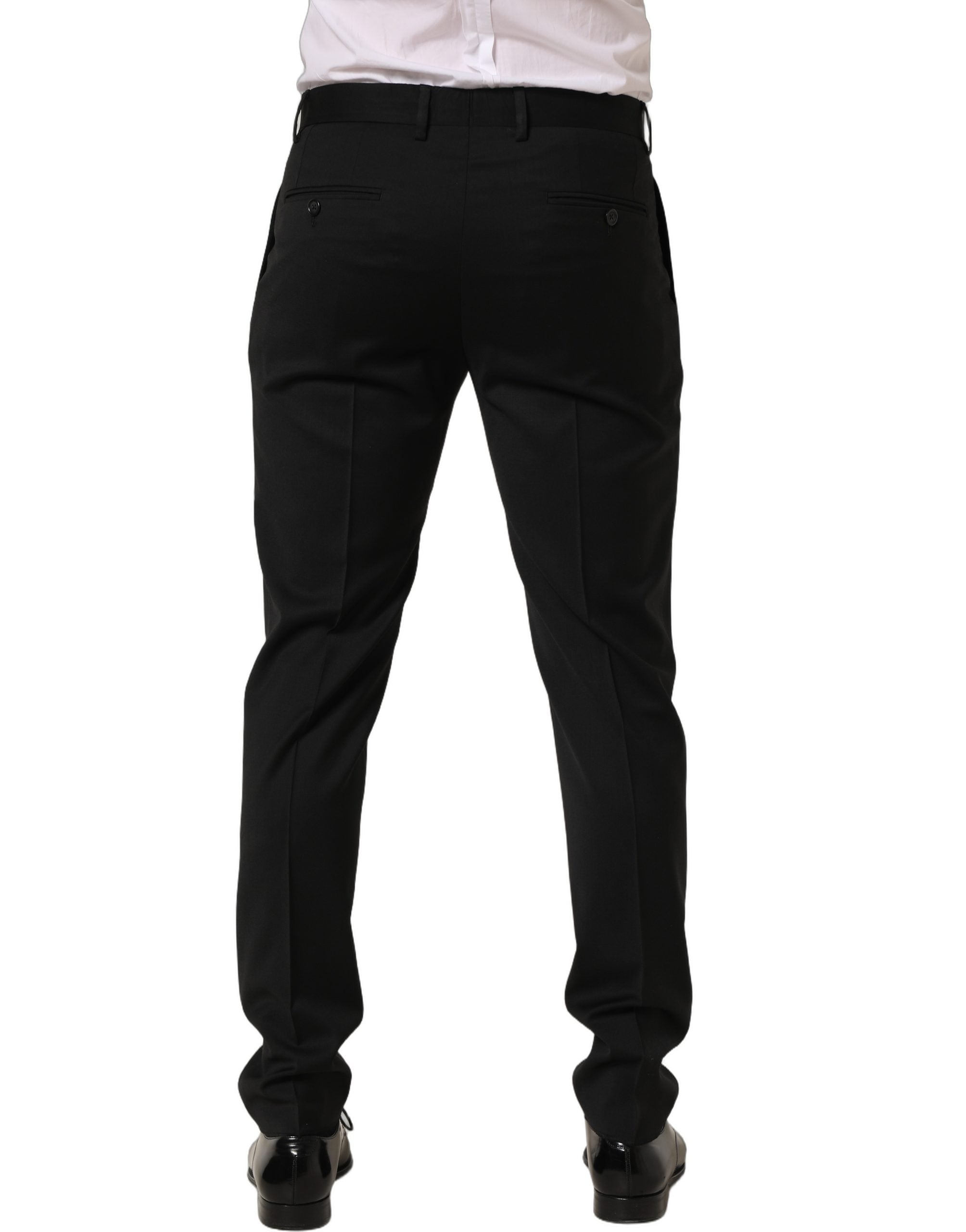 Pantalon homme Dolce & Gabbana en laine noire, coupe tapered, style pantalon de costume habillé, visible en détail.