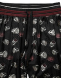 Pantalons Dolce & Gabbana en soie noire avec motif de bagues, style jogging confortable, vue de devant.