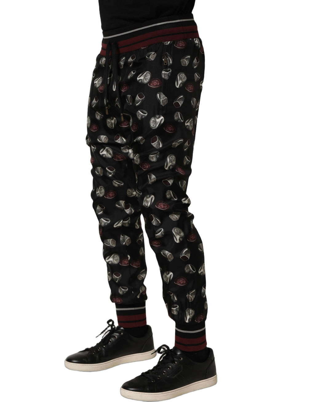 Pantalons Dolce & Gabbana en soie noire avec imprimé anneaux, joggings élégants et confortables.