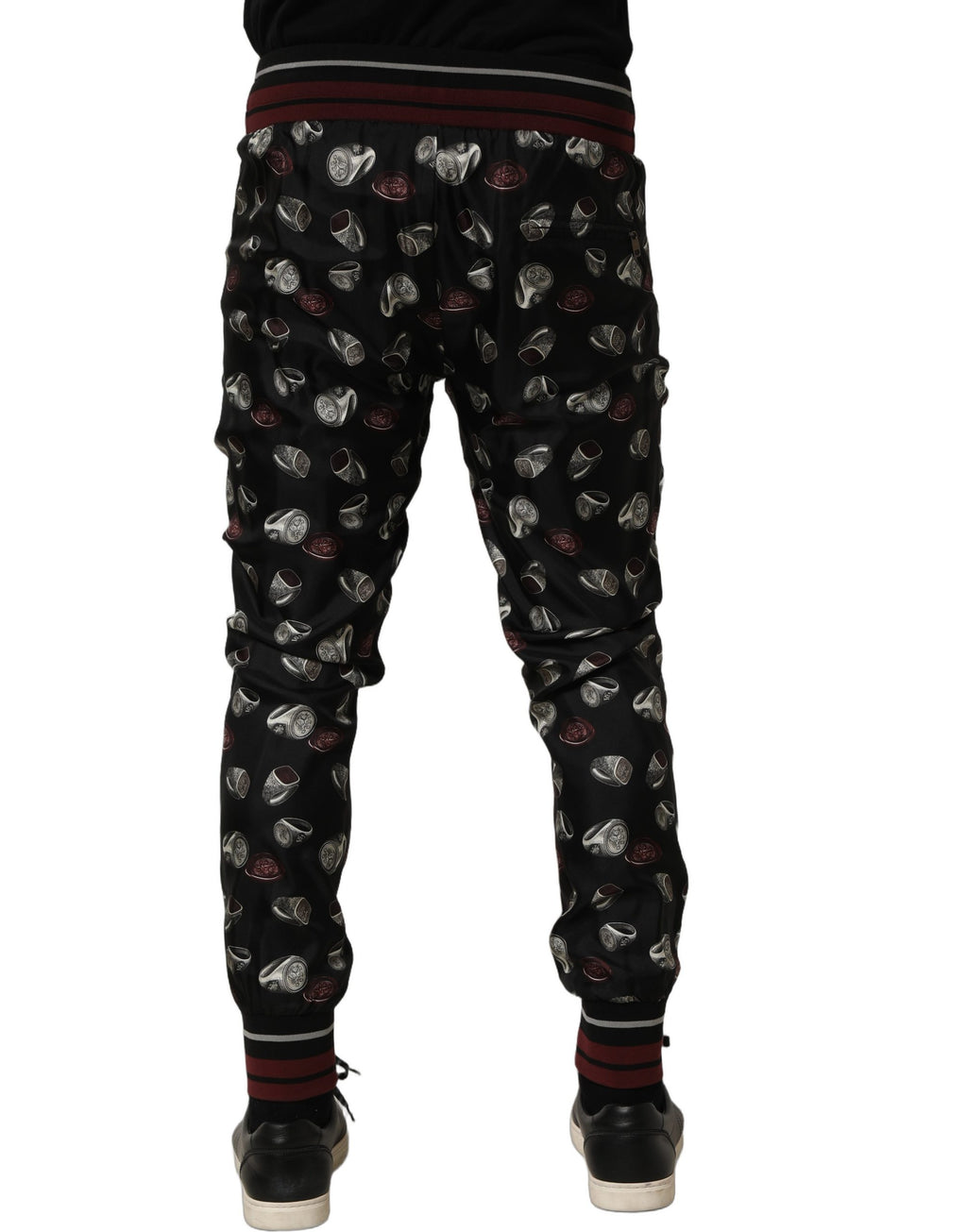 Pantalons Dolce & Gabbana en soie noire à motif de cercles, style jogging élégant et confortable.