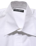 Chemise blanche en coton sans manches de costume Dolce & Gabbana, boutonnière élégante et finition soignée visible sur l'image.