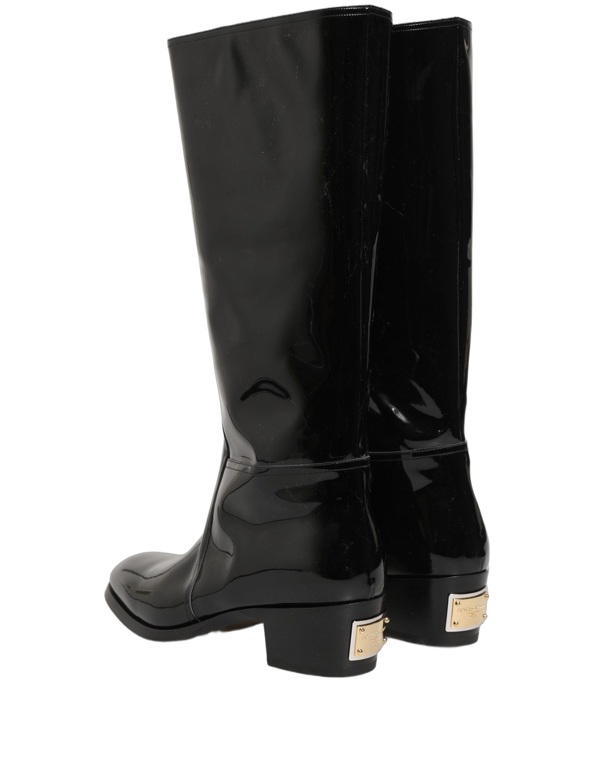 Bottes à talons hauts en cuir noir de la marque Dolce & Gabbana, cuissardes élégantes et sophistiquées.