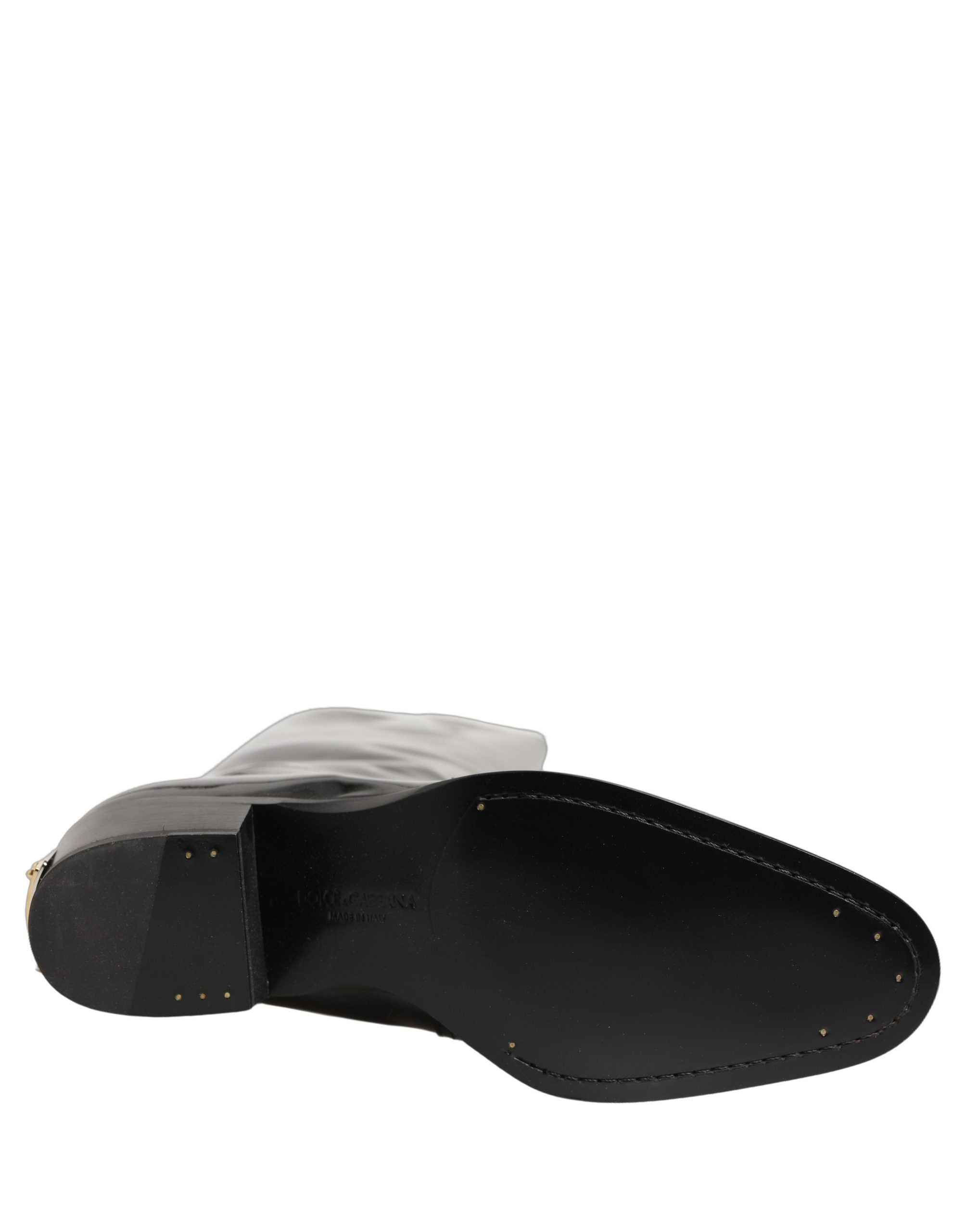 Chaussures bottines en cuir noir Dolce & Gabbana, talons hauts et genou, élégantes et sophistiquées pour femmes.