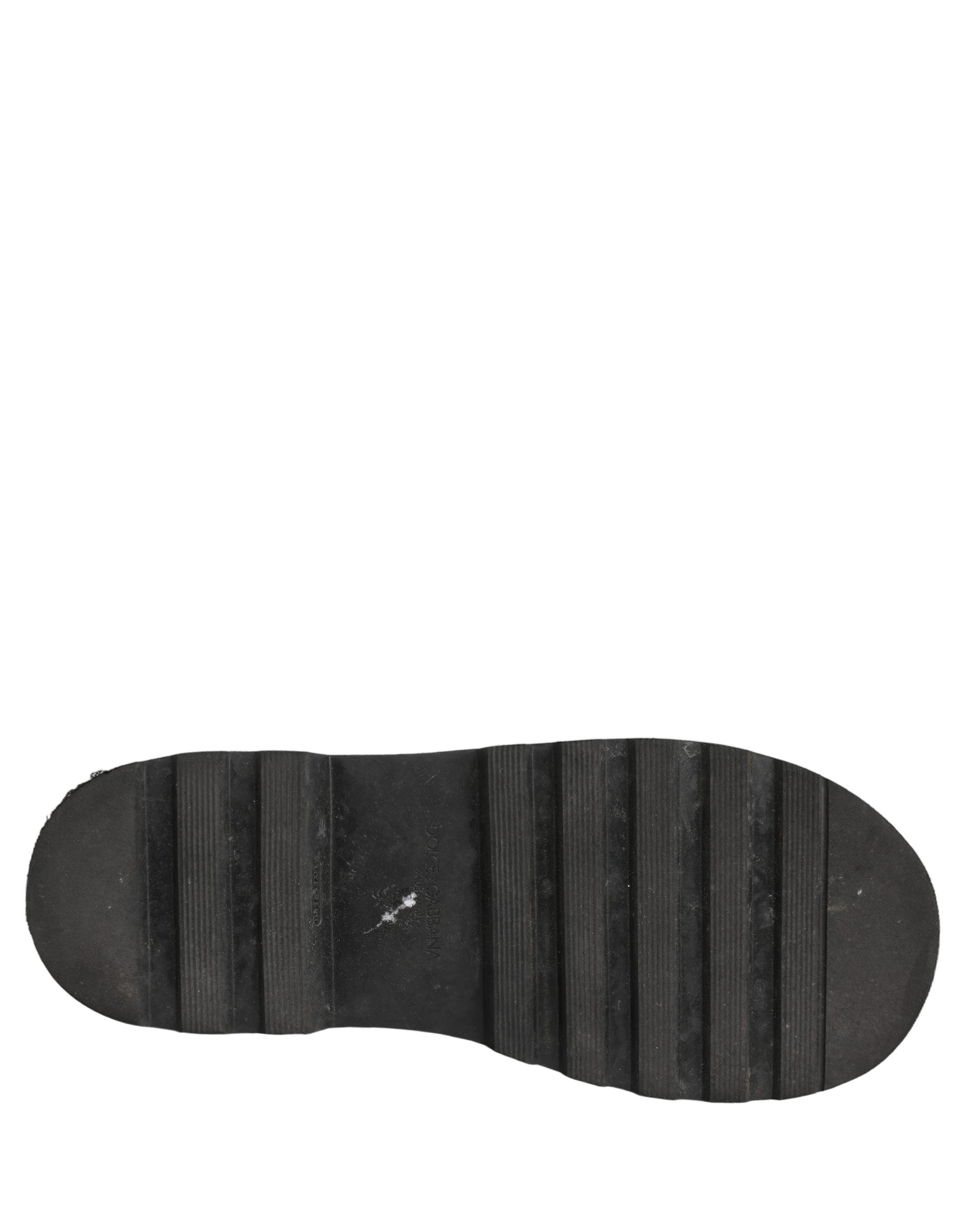Bottes combat en cuir noir pour homme de Dolce & Gabbana avec lacets, style robuste et élégant.