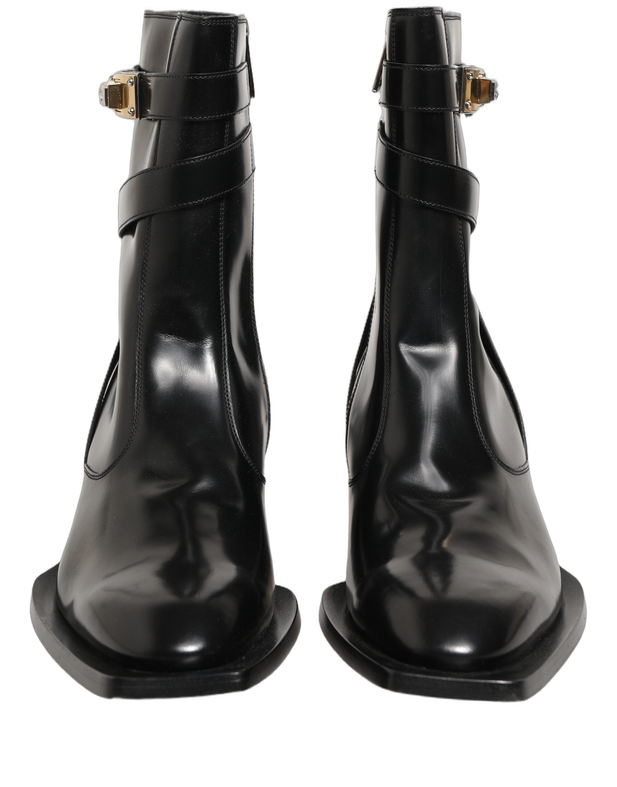 Bottes hautes en cuir noir Dolce & Gabbana avec plaque DG, semelle en cuir, style élégant et sophistiqué.