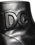 Bottes ankle en cuir noir Dolce & Gabbana avec logo embossé, style élégant et moderne.