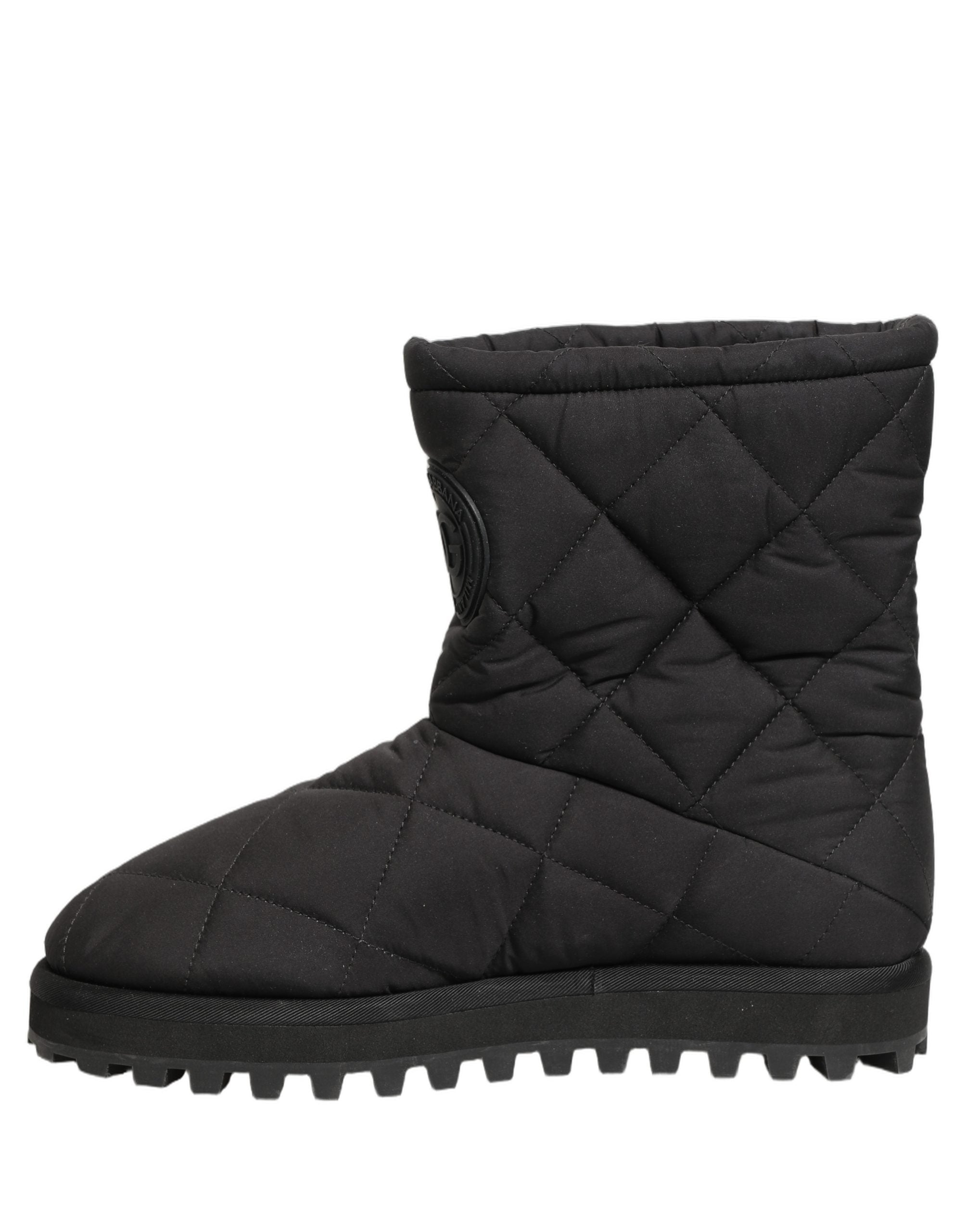 Bottes mi-mollet noires Dolce & Gabbana avec effet matelassé, semelle en cuir et design élégant.
