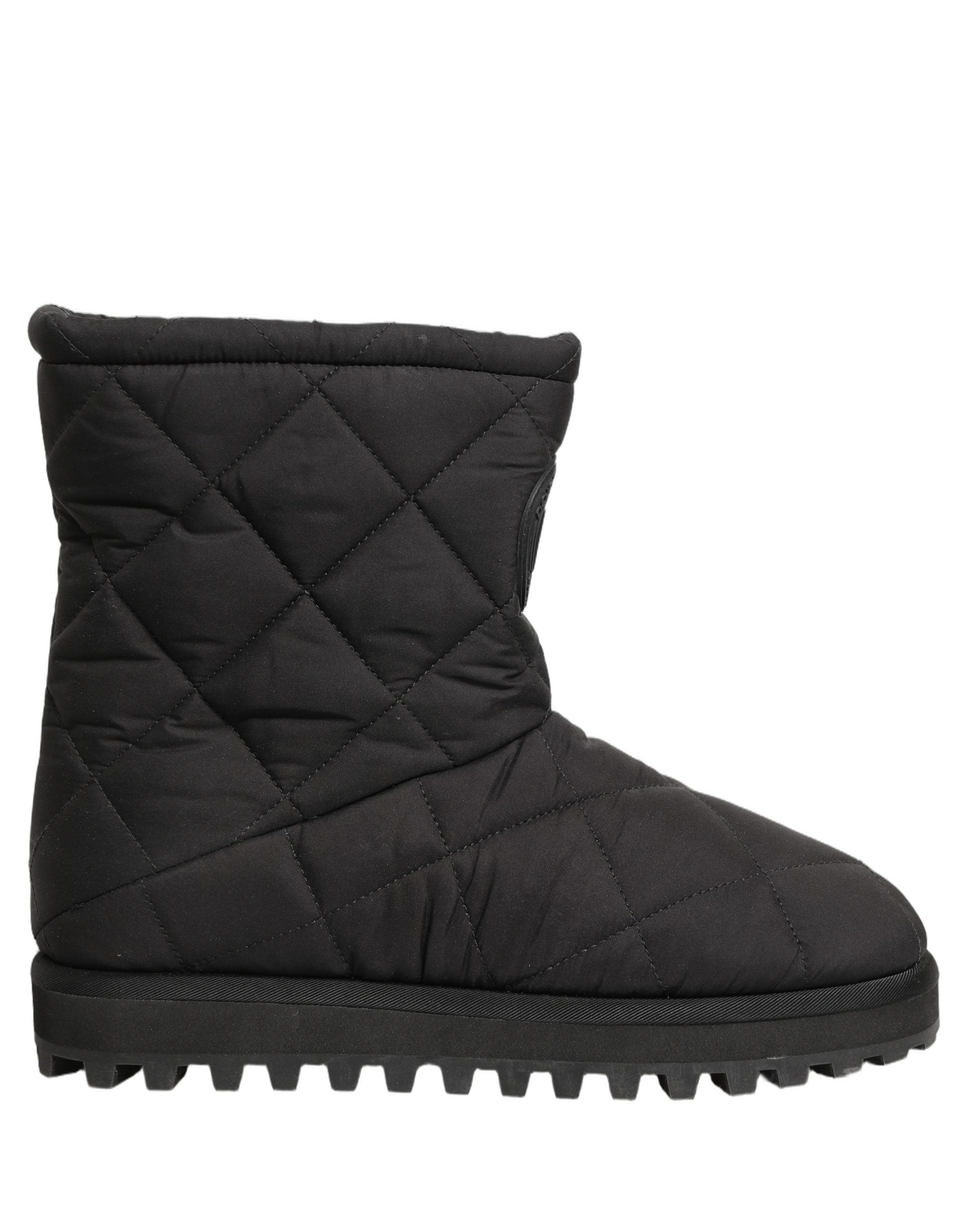 Bottes mi-mollet noires en effet matelassé Dolce & Gabbana, chaussures élégantes en cuir avec semelle robuste.