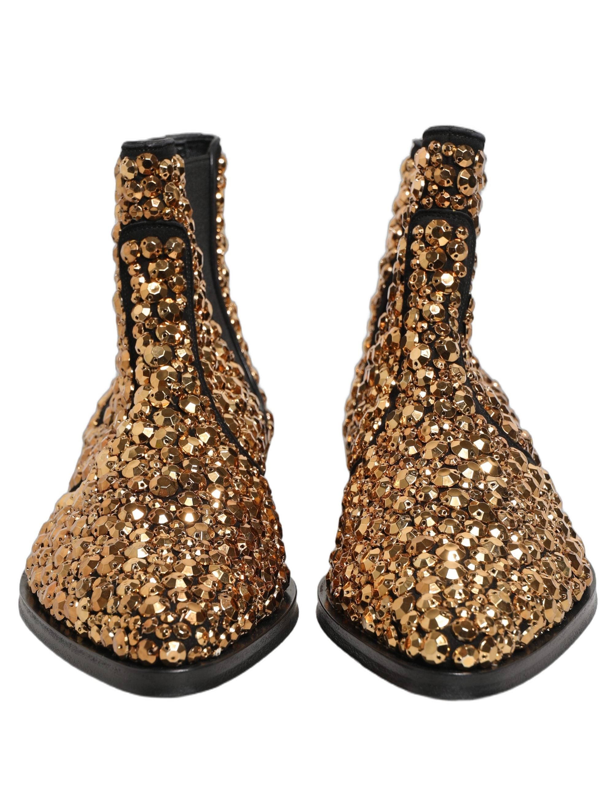 Bottes Chelsea dorées Dolce & Gabbana avec embellissements, ankle boots élégantes en cuir avec détails métalliques.