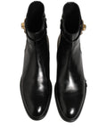 Bottes en cuir noir Dolce & Gabbana avec boucle à logo, mi-mollet, chaussures élégantes et modernes.