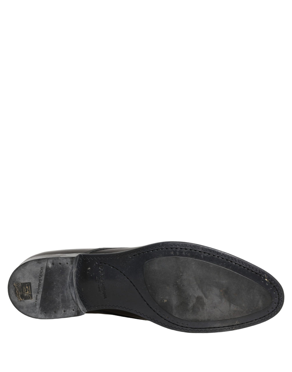 Chaussures Derby en cuir noir de Dolce & Gabbana, lacets, style élégant et classique, visibles en gros plan.