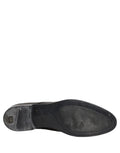 Chaussures Derby en cuir noir de Dolce & Gabbana, lacets, style élégant et classique, visibles en gros plan.