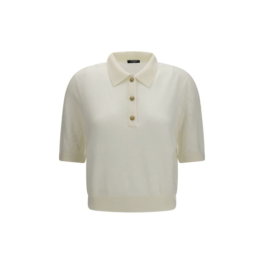 Chemise polo blanche en laine Balmain Oves Aries avec col classique et logo brodé, portée sur un mannequin.