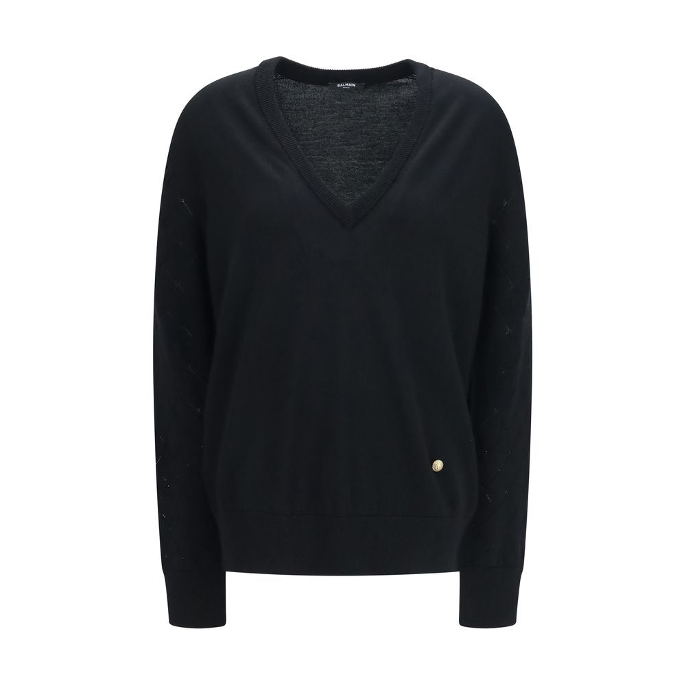Sweat-shirt noir en laine Balmain Oves Aries avec logo brodé, porté sur mannequin, détails de couture visibles.