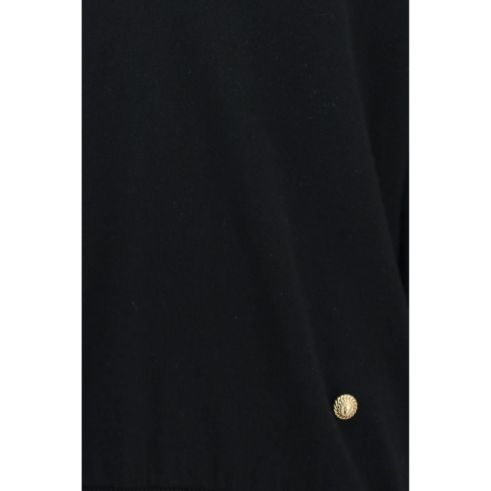 Sweatshirt en laine noire Balmain Oves Aries, style décontracté avec logo brodé, porté sur un modèle.
