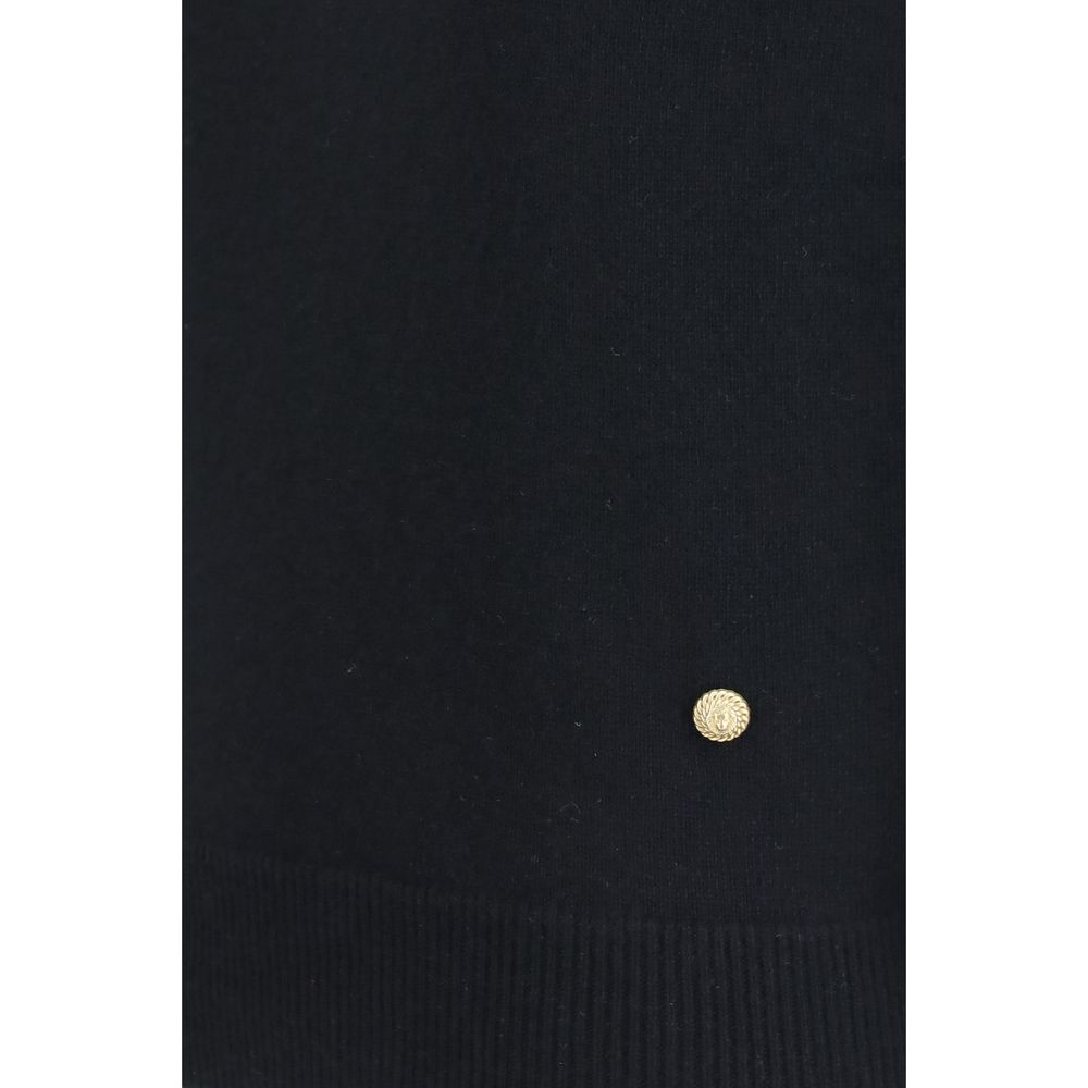 Pull noir en laine Balmain Oves Aries sans manches, modèle élégant avec détails sophistiqués, porté sur un fond neutre.