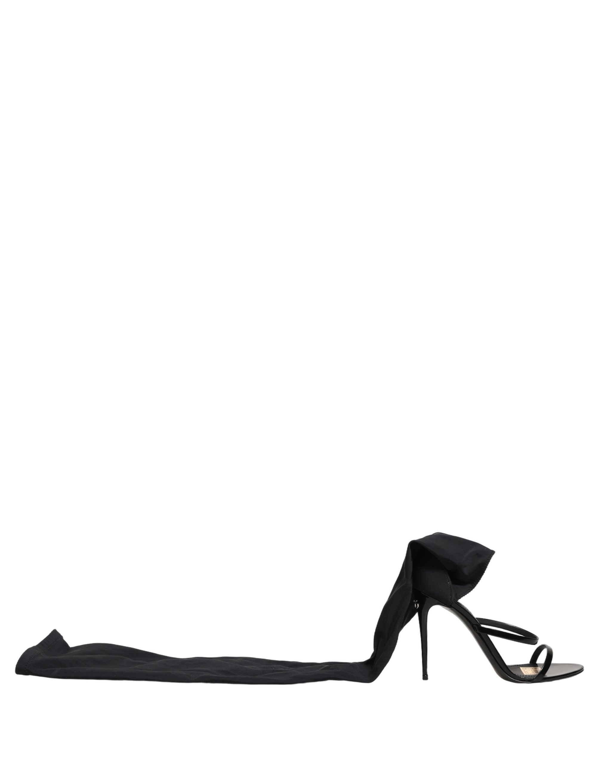 Sandales stilettos Dolce & Gabbana avec chaussettes intégrées et bottes hautes en cuir noir, vue de face.